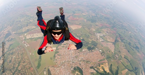 Empowered woman jumping from parachute.