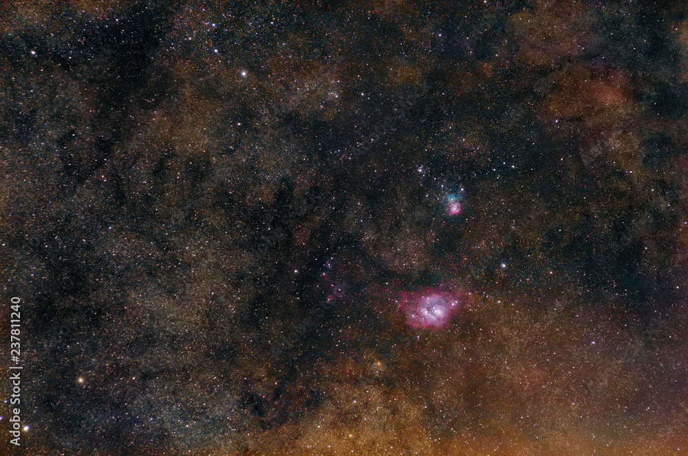 Lagoon nebula and Trifid nebula on Milky Way starry background.