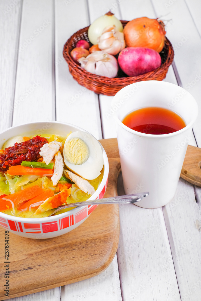 Lontong-Traditional Malaysian and Indonesian food on wooden table with spoon. Lontong-Traditional Malaysian and Indonesian food on wooden table with spoon.