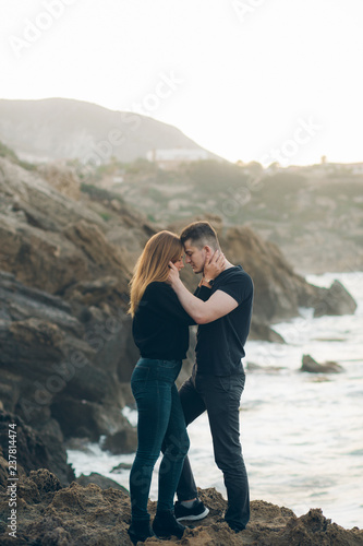 Couple in love on the rocks by the sea