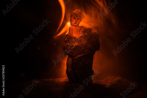 Horror silhouette of scary figure at night. Female demon. Demons coming. Slhouette of devil or monster figure on a background of fire.