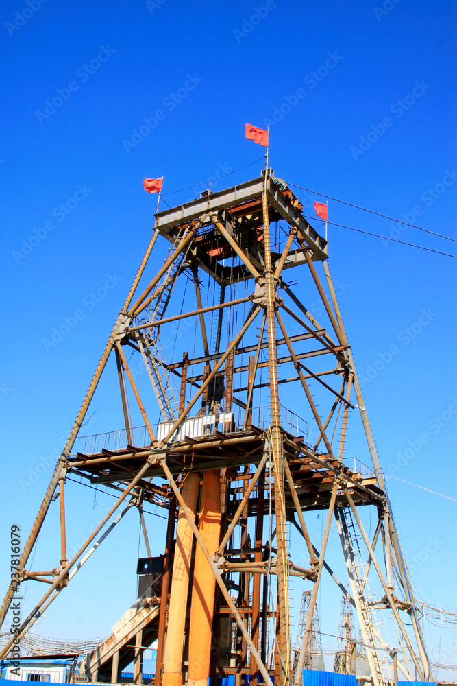 Iron ore drilling derrick in the blue sky background Iron ore drilling derrick in the blue sky background