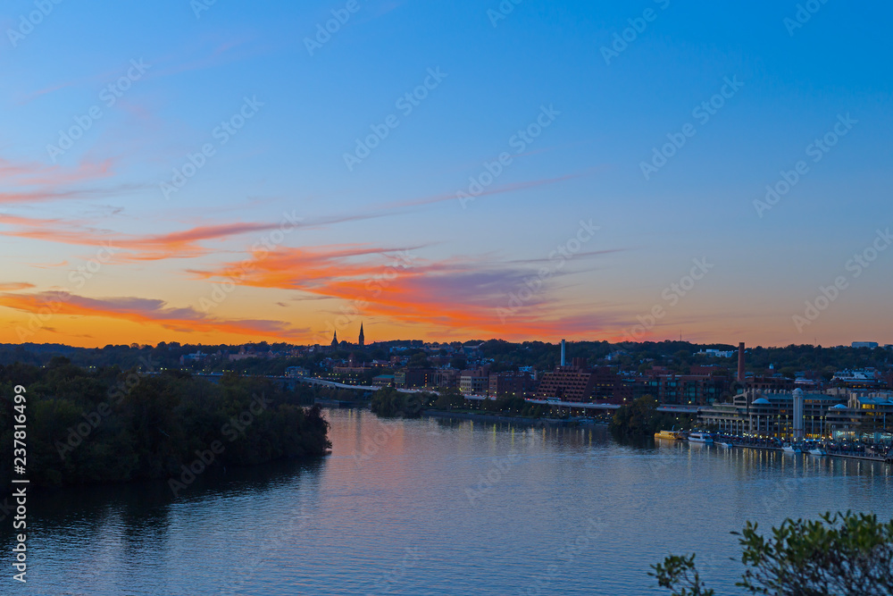 Bright autumn sunset over Georgetown waterfront in Washington DC, USA. Urban US capital panorama along Potomac River.