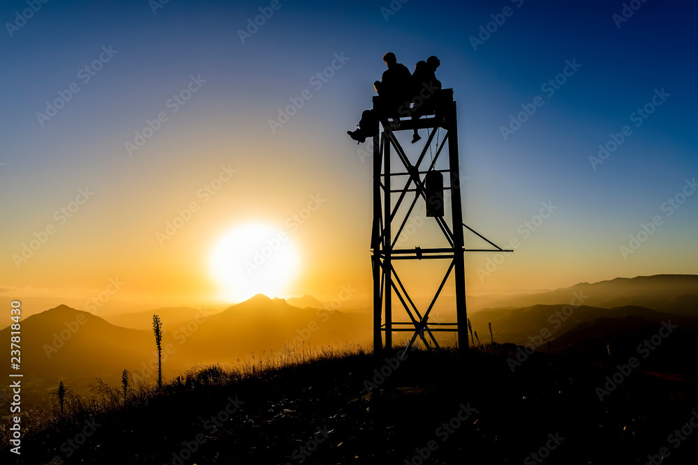 Silhouetted Tower with Boys on Top at Sunset