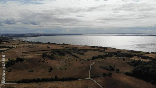 Aerial view of the coastline of Sejer√∏bugten with hills, fields and ocean. photo