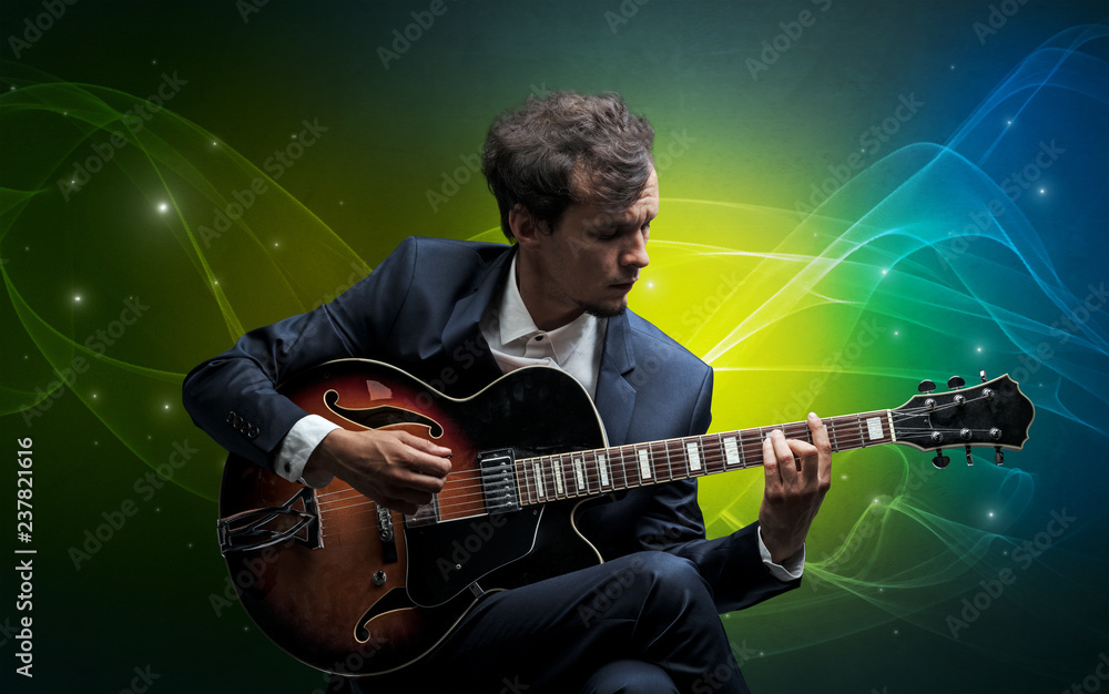 Obraz premium Serious classical guitarist with fabled sparkling wallpaper