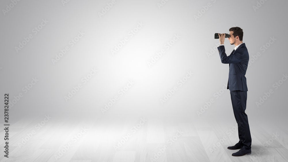 Businessman looking forward with binoculars in an empty space
Businessman looking forward with binoculars in an empty space