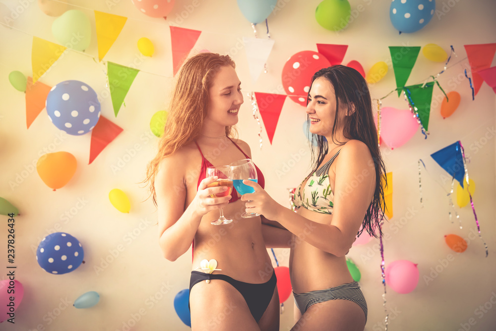 party time of beautiful women in bikini dress drinking alcohol champagne  celebrating new year, birthday, fun and happiness Stock Photo