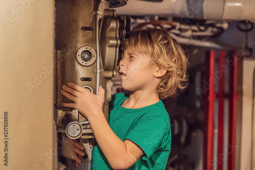 The boy looks through the periscope on the submarine photo