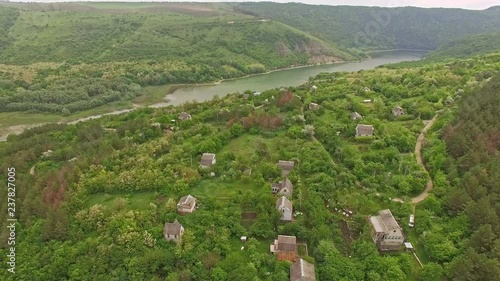 Amazing aerial view of small mountain village and river in Ukraine photo