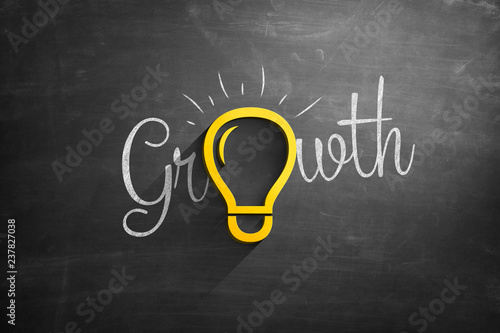 Light bulb icon on blackboard with growth text