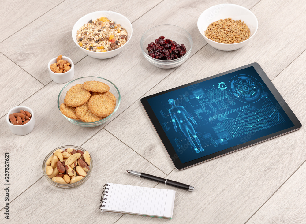 Healthy food composition with tablet. Body diagnosis on the screen Healthy food composition with tablet. Body diagnosis on the screen