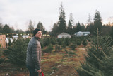 A man smiling at the Christmas tree farm. 
