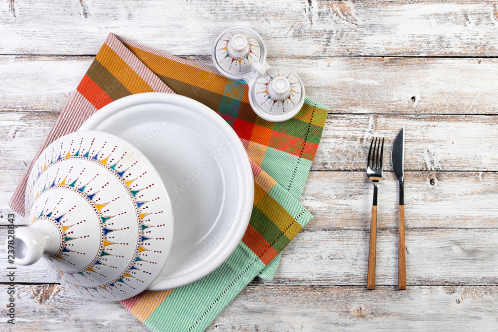 tableware tajin (tazhin) on a wooden background, top view, copy-space tableware tajin (tazhin) on a wooden background, top view, copy-space