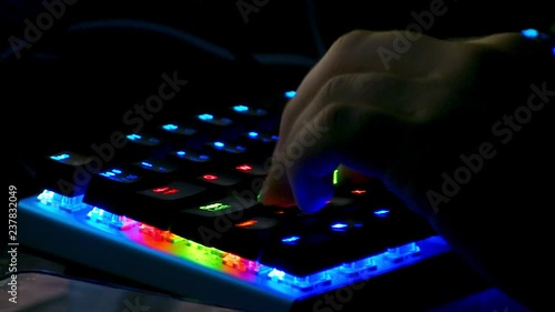 A gamer using his keyboard while gaming on his PC. photo