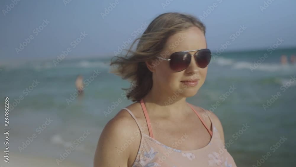 Close up portrait of Beautiful Young Woman smiling hair blowing in wind on tropical beach 4k Close up portrait of Beautiful Young Woman smiling hair blowing in wind on tropical beach 4k
