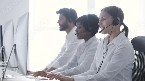 Call Center Agents Consulting Clients On Hotline At Office