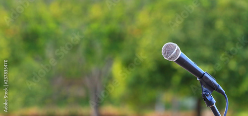 microphone standing for speaker on the outdoor natural setting for music, concert and environmental awareness talk with copy space