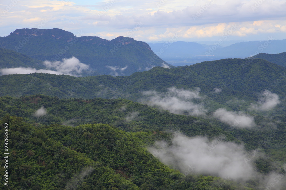 Mist hanging over the mountain of tropical rain forest in rainy season