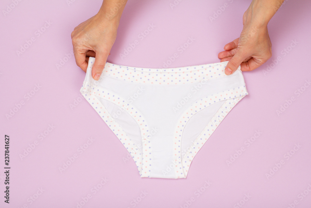 Women's hands with beautiful panties on lilac background. Women's hands with beautiful panties on lilac background.