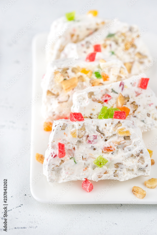 White nougat slices on white plate White nougat slices on white plate