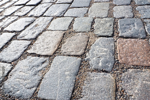 Cobblestones old pavement. The background of the cobbled paved stone road. 