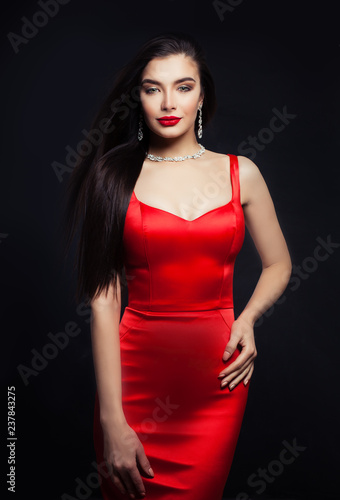 Girl in red silky dress. Perfect brunette woman portrait