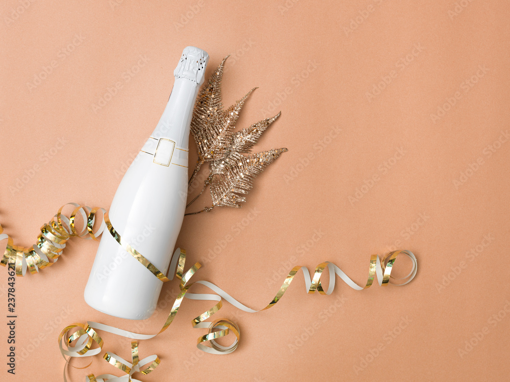new year background with bottle of champagne on bronze, gold, brown background with different New Year's Eve items new year background with bottle of champagne on bronze, gold, brown background with different New Year's Eve items
