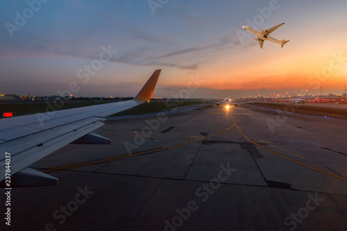 Airplane is taxiing to the runway for take off in beautiful sunset. photo