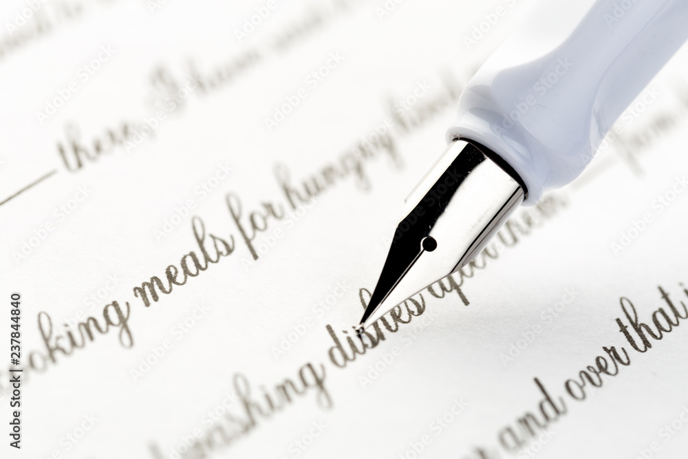 white fountain pen writing a letter