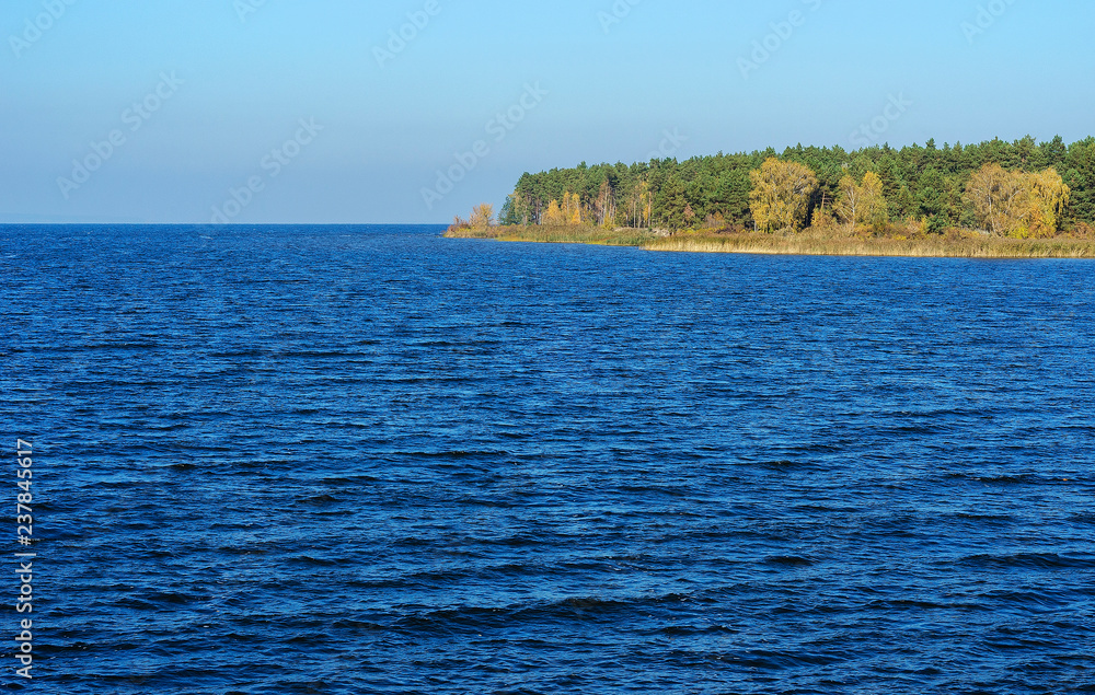 Naklejka premium blue sea with a shore in the distance 2