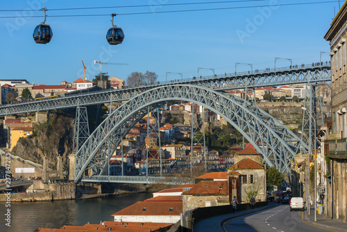 View of the famous bridge Ponte dom Luis and cable cars in Porto, Portugal