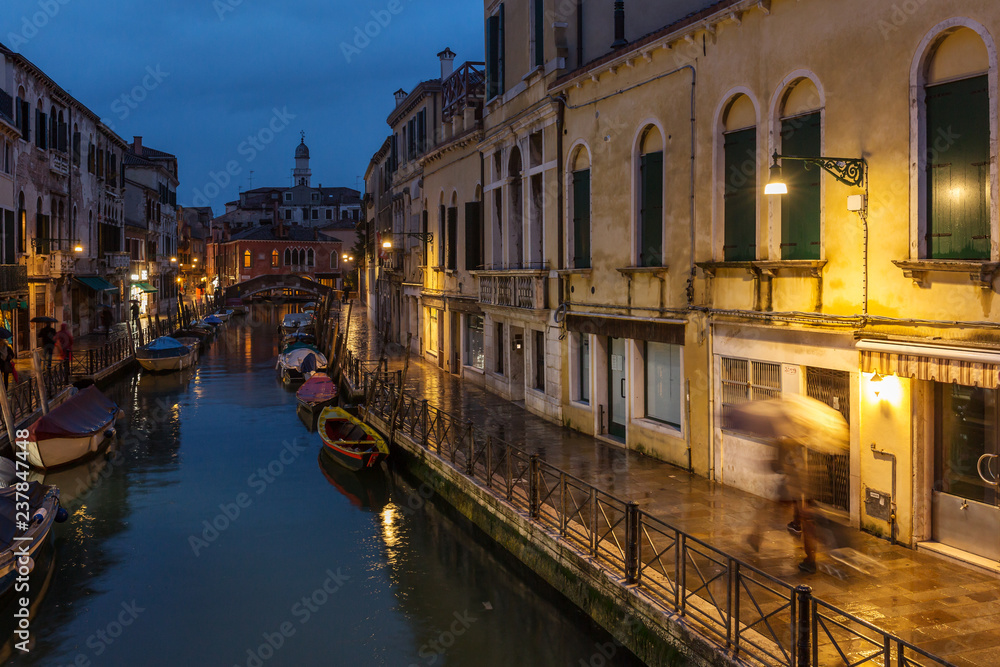 Side Canal at night in Venice, Italy.