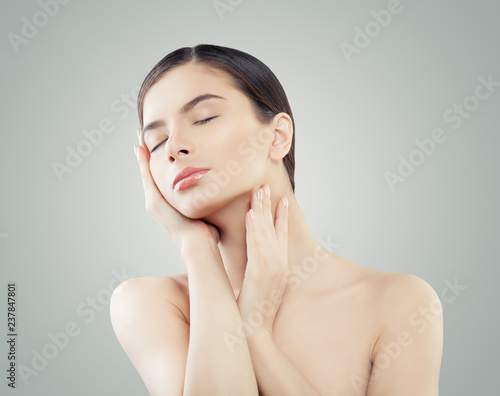 Healthy young woman with perfect skin. Facial treatment, wellness and spa concept