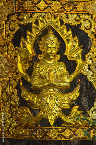 Brass plate carved in Thai style .
