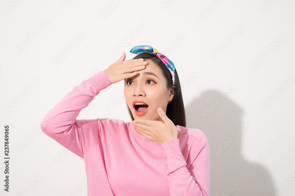 Asian woman touching her face with surprise feeling, with joy and happiness, pink shirt, white background Asian woman touching her face with surprise feeling, with joy and happiness, pink shirt, white background