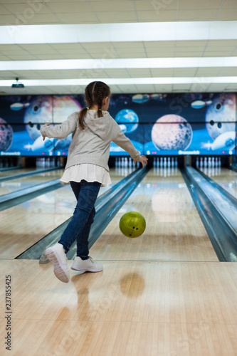 Young girl playing bowling