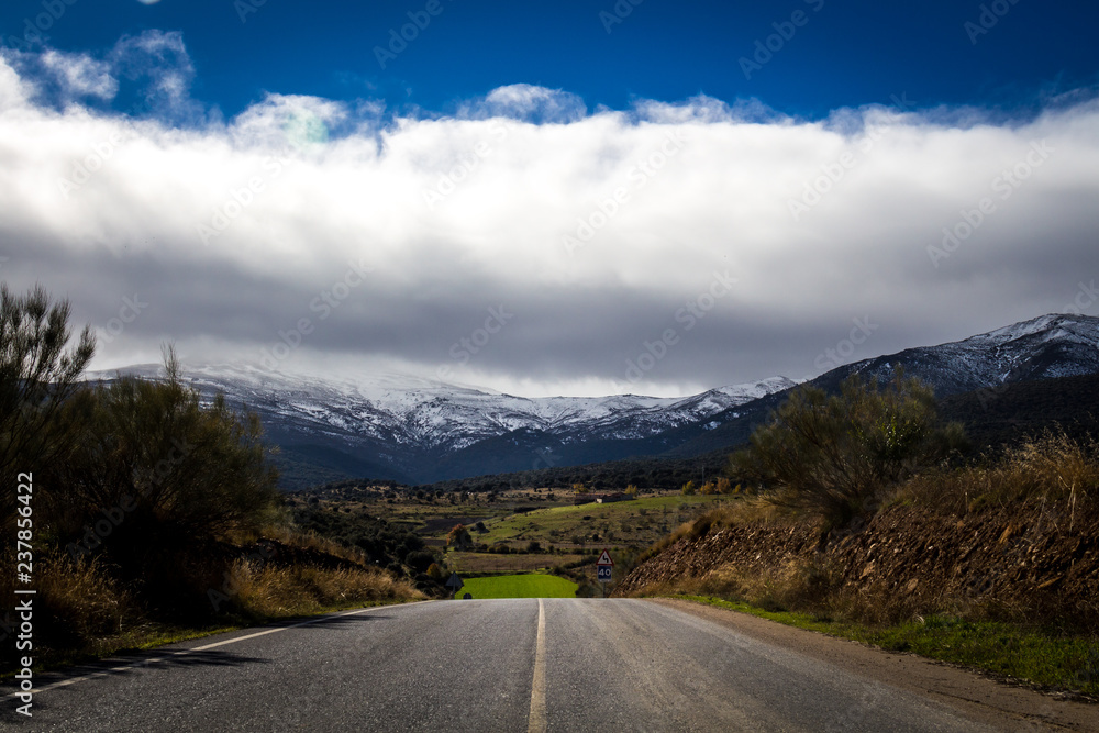 Granada, Spain; November 07, 2018: landscape with road and snowy mountain in the background, in this case Sierra Nevada, Granada