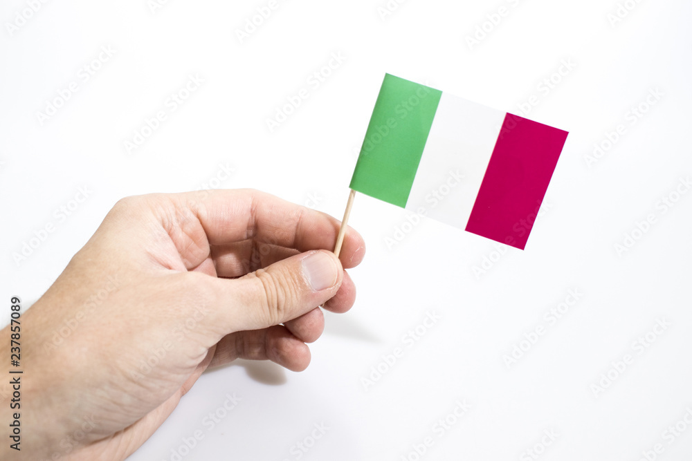 Hand is holding italian flag isolated in a white background Hand is holding italian flag isolated in a white background