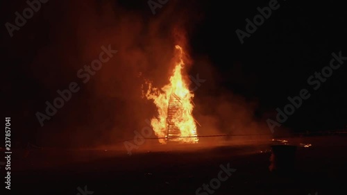 Burning pyre in slow motion, falling appart