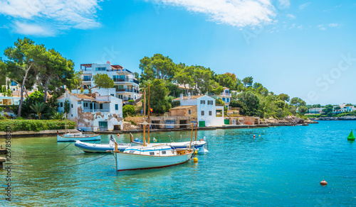 Landscape with boat and Cala D'or village, Palma Mallorca Island, Spain photo