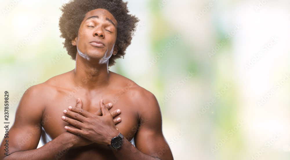 Afro american shirtless man showing nude body over isolated background