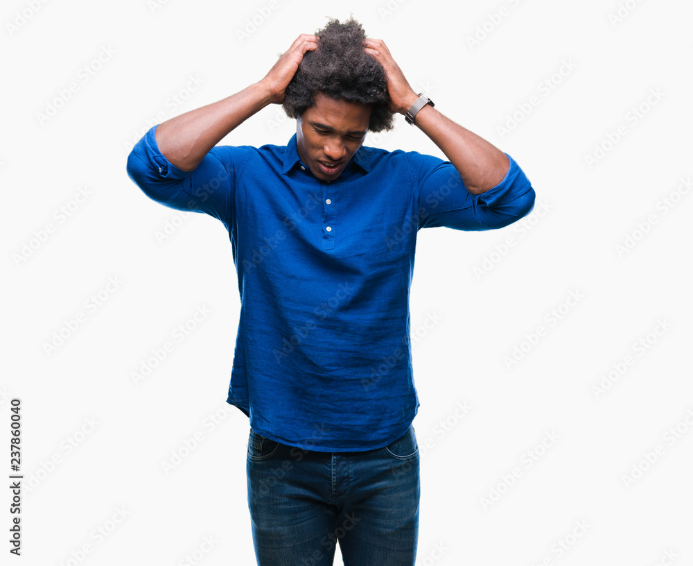 Afro american man over isolated background suffering from headache desperate and stressed because pain and migraine. Hands on head. Afro american man over isolated background suffering from headache desperate and stressed because pain and migraine. Hands on head.