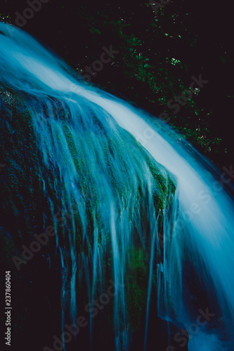 Magic blue waterfall at the forest.  Natural fairy waterfall steam water. photo