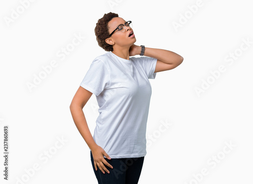 Beautiful young african american woman wearing glasses over isolated background Suffering of neck ache injury, touching neck with hand, muscular pain