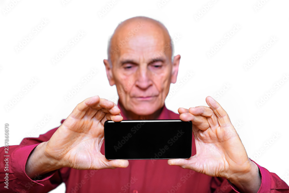 black phone in the hands of an older elderly man for photographing, isolated on white background black phone in the hands of an older elderly man for photographing, isolated on white background