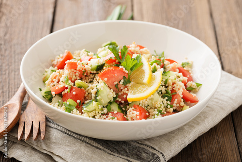 Couscous with parsley, tomato, lemon and olive oil. Traditional Arabic Salad Tabbouleh.