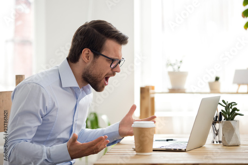 Pissed off computer operator fed up with loud colleague listening to music  and pretending to beat drums at work. Businessman annoyed by bothersome  coworker perturbing him in office 32623414 Stock Photo at
