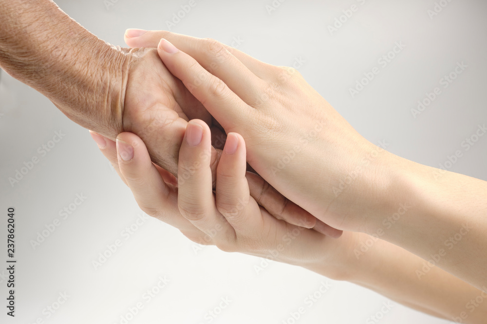 Elderly Care Concept, Close-up photos of Young hands is holding Hands full of wrinkles. Elderly Care Concept, Close-up photos of Young hands is holding Hands full of wrinkles.
