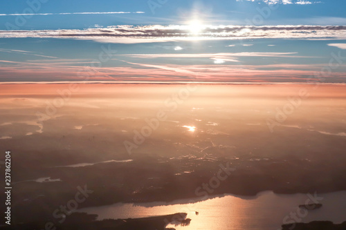 Fototapeta Naklejka Na Ścianę i Meble -  The view from an airplane. Sunrise early morning.